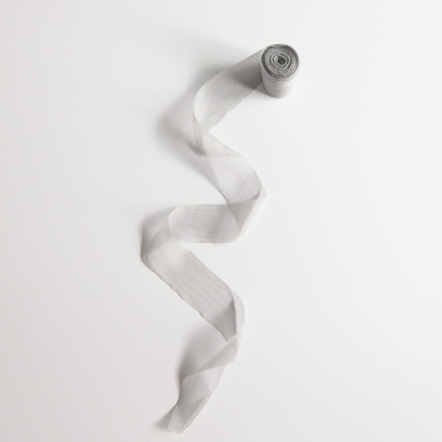 Close-up of ribbon pleats showing soft and airy chiffon texture
