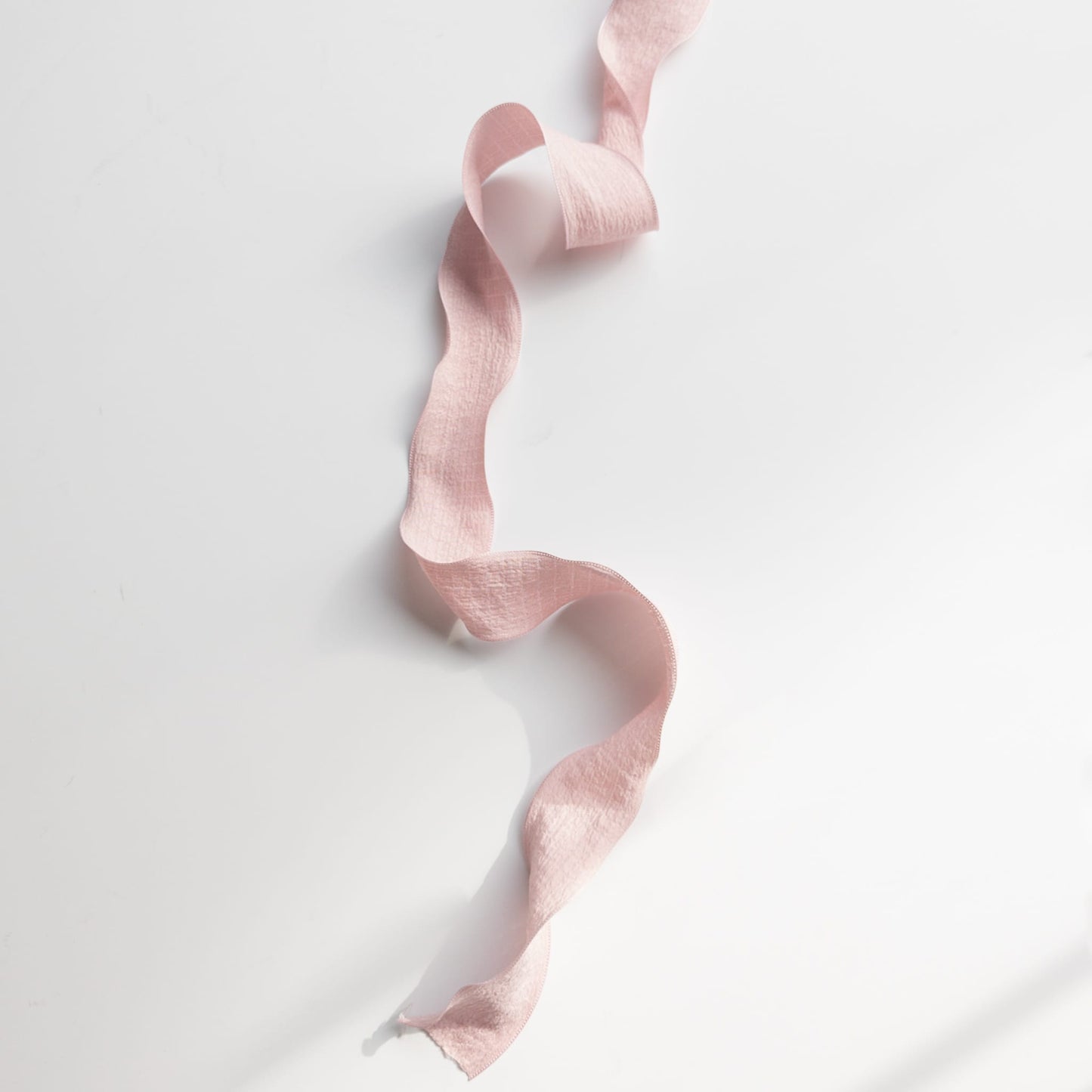 Stack of old fashioned ruffle ribbons in various colors for crafting

