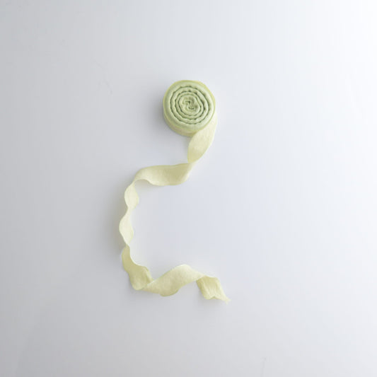 Old fashioned ruffle ribbon styled with dried flowers for rustic gift décor
