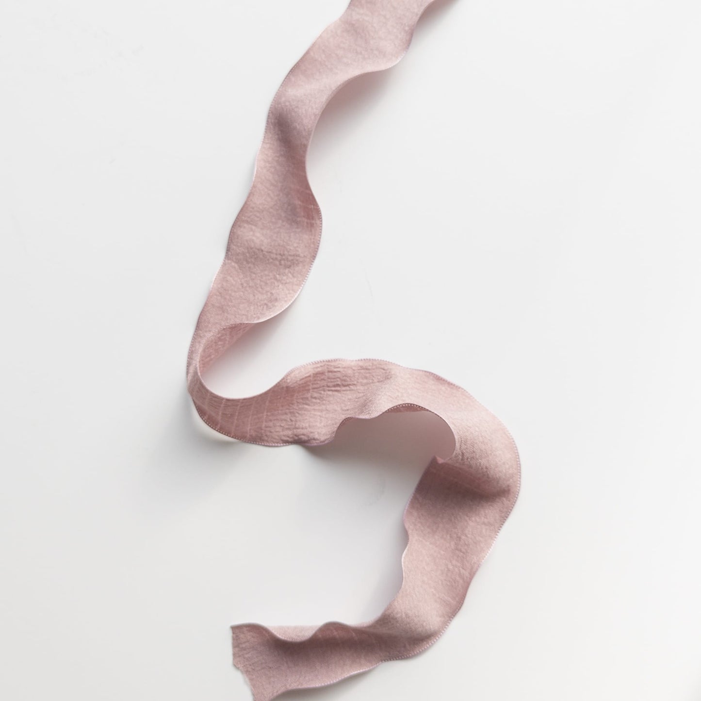 1.5-inch ruffle ribbon draped over a wooden table for vintage décor styling
