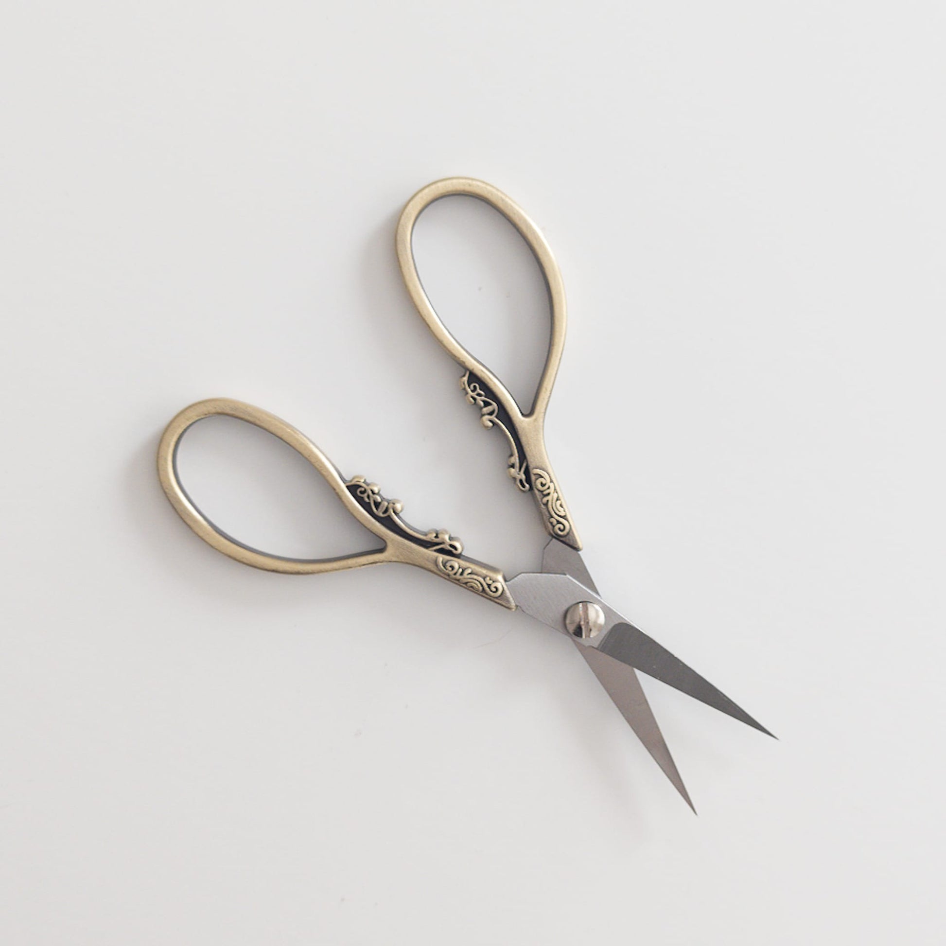 Intricately designed scissors with a brass finish for stylish crafting
